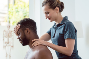 Whiplash-Doctor-Bethesda-MD-man-having-neck-examined-by-woman-doctor