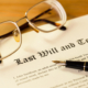 How An Estate Planning Lawyer Can Help - Last will and testament with pen and glasses concept for legal d